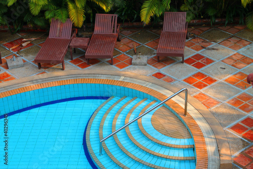 Wooden pool trestle beds by the poolside