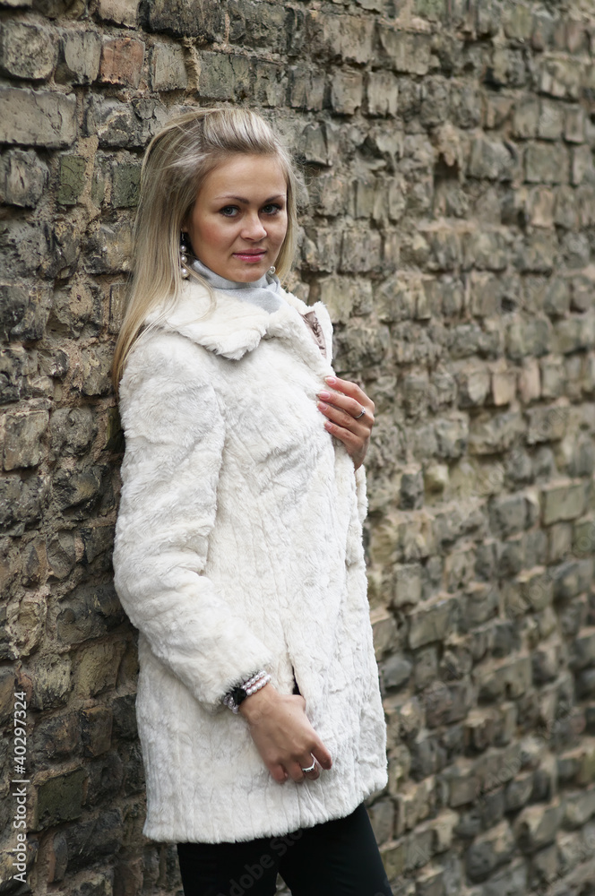 Upset Young Woman In White Fur Coat