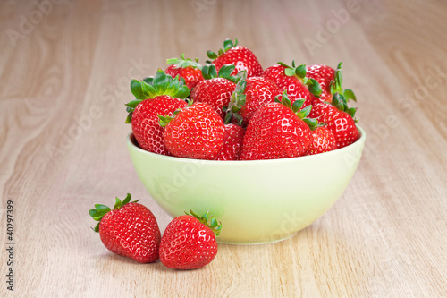 strawberries in a plate on the wooden table