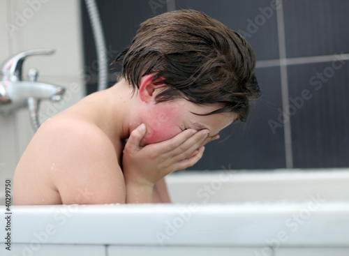 Teen boy experiencing a problem in the bathroom