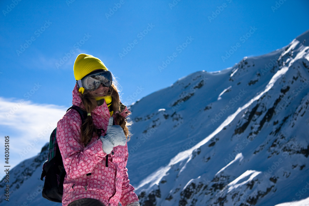 Girl in bright clothes in mountains