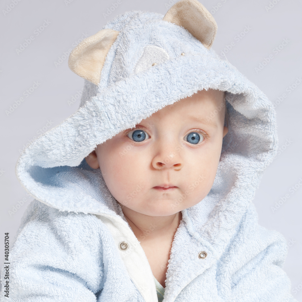 portrait of a cheerful child in blue bathrobe portrait of a cheerful child in blue bathrobe