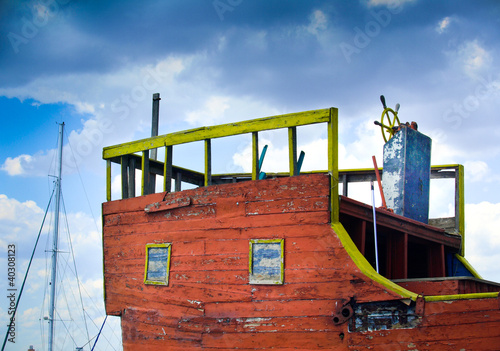 Old piscatorial boat on sea shore