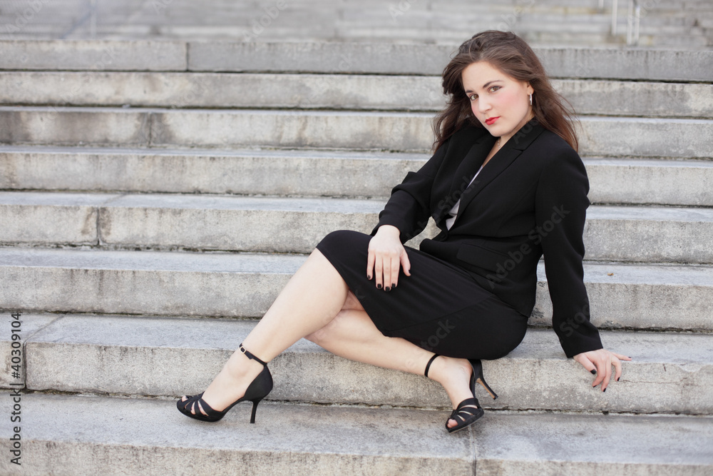 Businesswoman posing on steps
