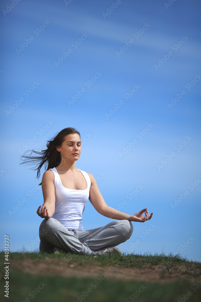 beautiful young girl training yoga near a lake beautiful young girl training yoga near a lake