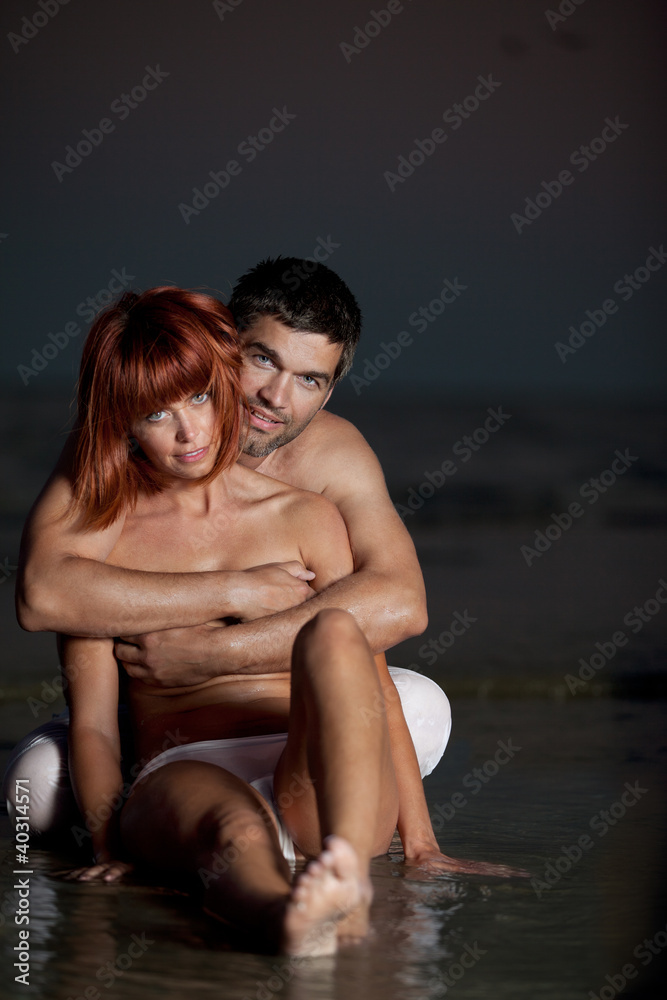 Fototapeta premium young couple having fun on the beach