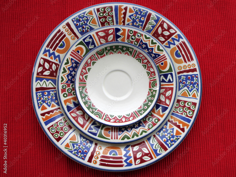 Naklejka premium Three colorful plates in red background