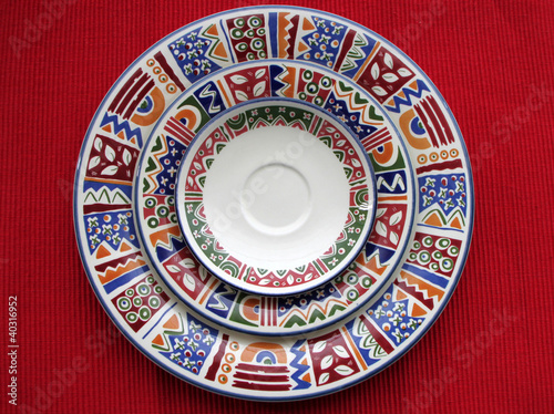 Three colorful plates in red background