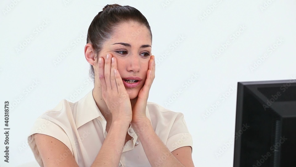 Young woman holding her face in her hands Young woman holding her face in her hands