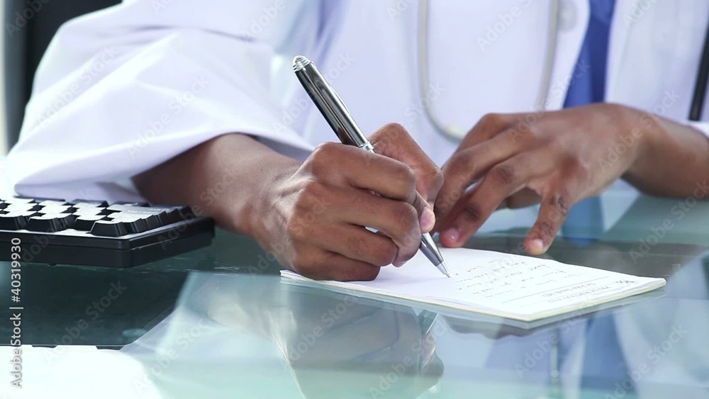 Black doctor writing a note