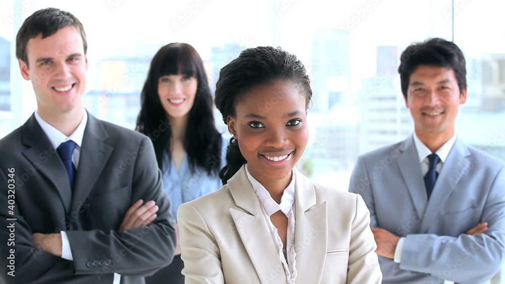 Happy work team standing with their arms crossed Happy work team standing with their arms crossed