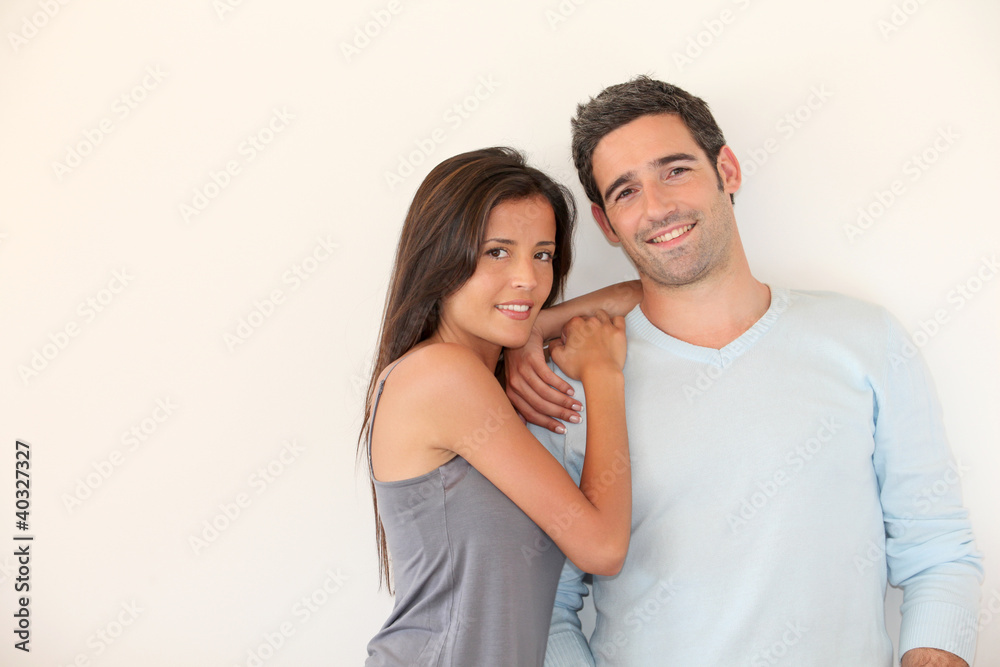 Trendy couple standing on white background