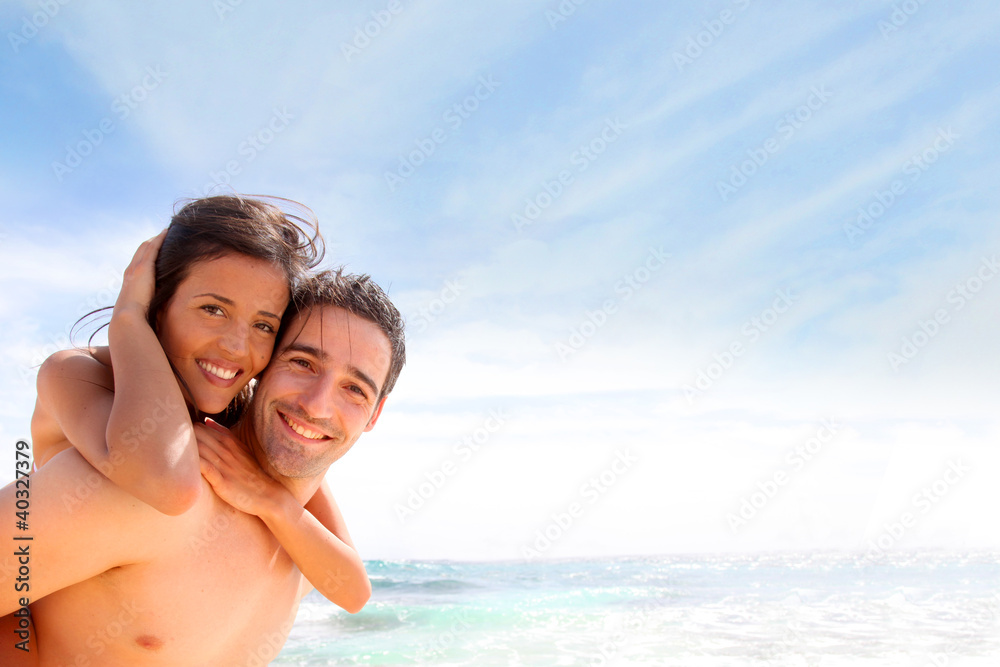 Portrait of man carrying girlfriend on his back Portrait of man carrying girlfriend on his back