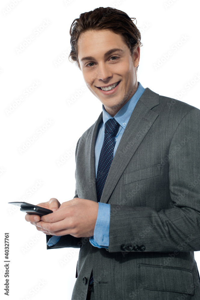 Handsome young man navigating on his smartphone Handsome young man navigating on his smartphone