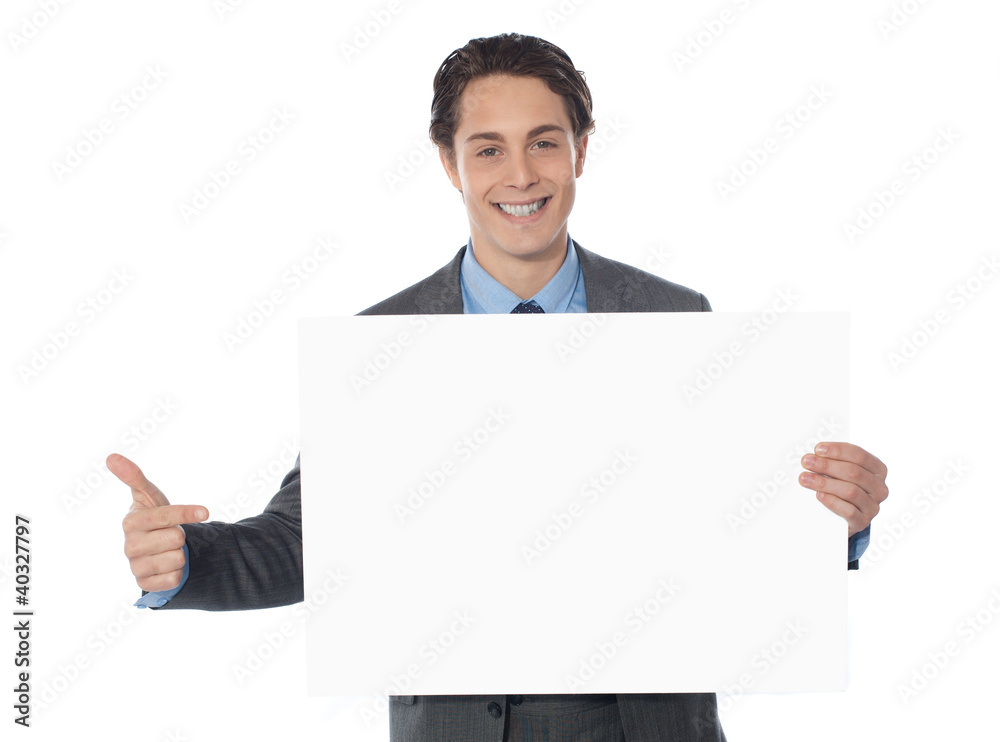 Male executive pointing towards blank billboard Male executive pointing towards blank billboard