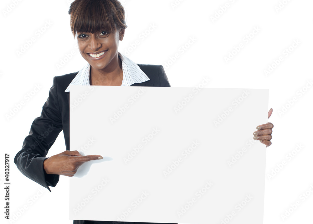 Corporate female executive pointing towards blank banner Corporate female executive pointing towards blank banner