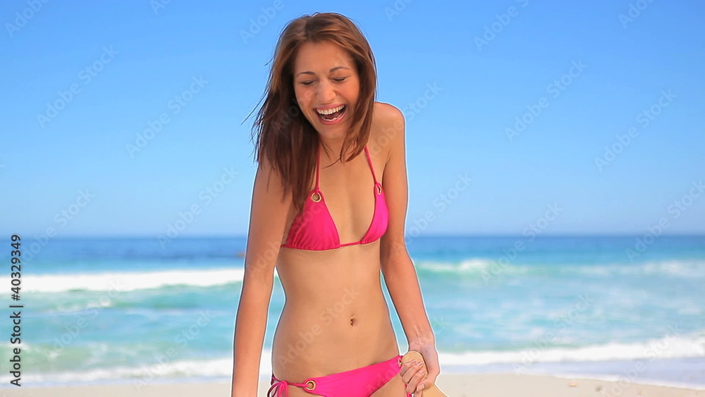 Happy brunette holding beach paddles Happy brunette holding beach paddles
