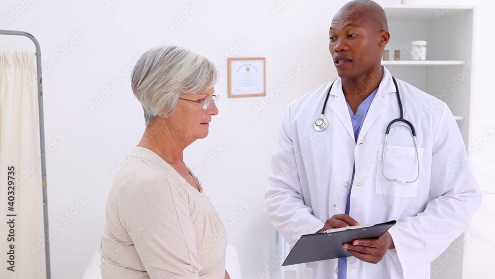 Smiling doctor talking with a mature woman Smiling doctor talking with a mature woman