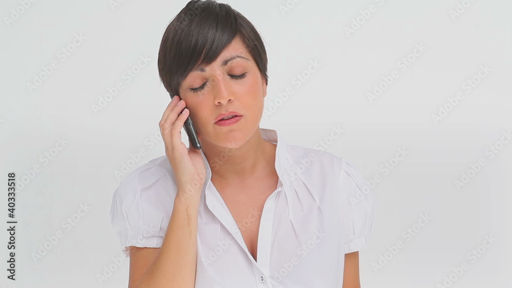 Businesswoman concentrating as she talks on a phone Businesswoman concentrating as she talks on a phone