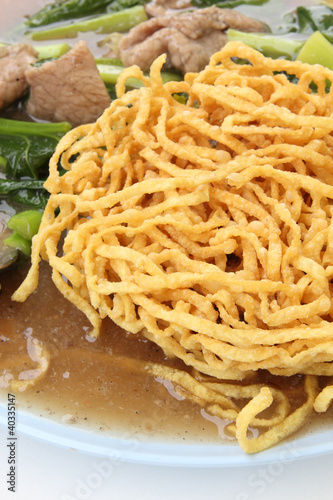 crispy yellow noodle with in a creamy gravy sauce