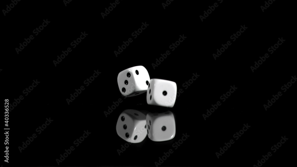 Two dices in super slow motion rebounding against a black background Two dices in super slow motion rebounding against a black background