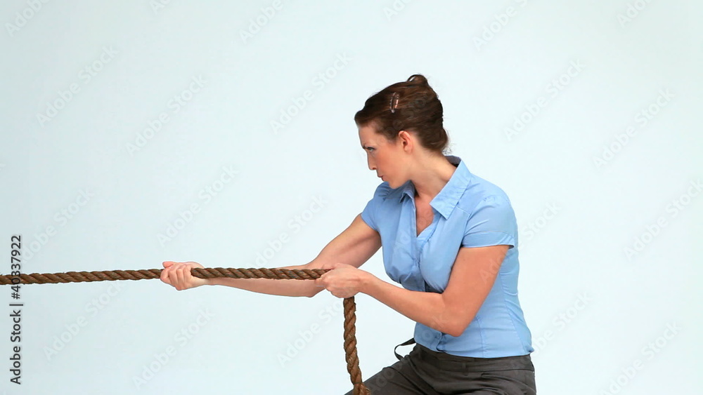 Young businesswoman pulling a rope