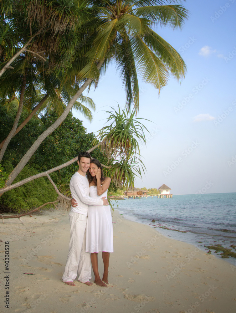 Sensual happy lovers in white clothes on the beach (Maldives) Sensual happy lovers in white clothes on the beach (Maldives)