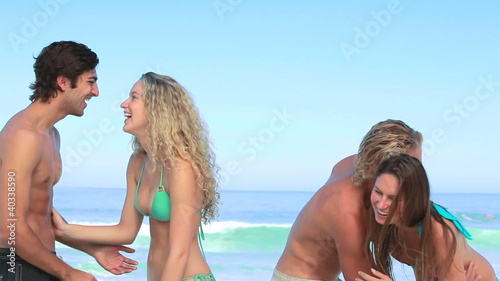 Two couples embracing together