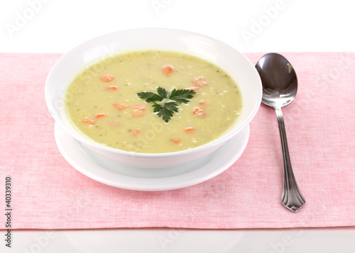 Tasty soup on pink tablecloth isolated on white