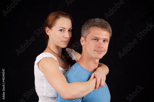 Romantic couple with her arms around his neck