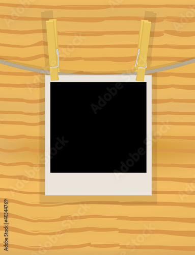 photo hanging on a rope over wooden wall illustration