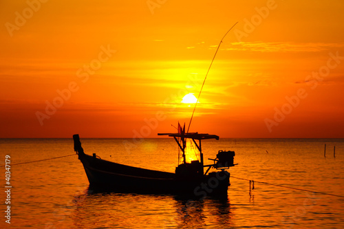 Tailed boat at sunset