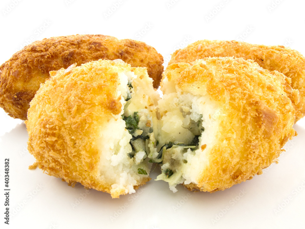 Three croquettes on white background with one is cutting Three croquettes on white background with one is cutting