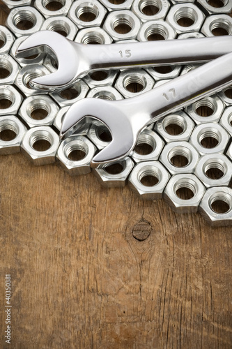 metal nuts and wrenches on wood