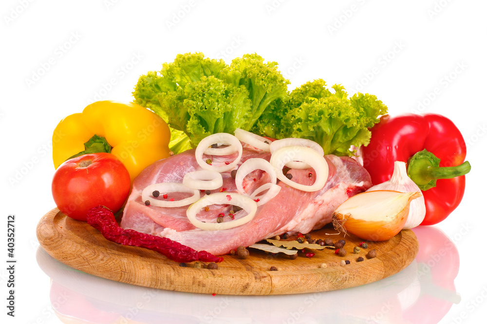 Raw meat and vegetables on a wooden board isolated on whitе Raw meat and vegetables on a wooden board isolated on whitе