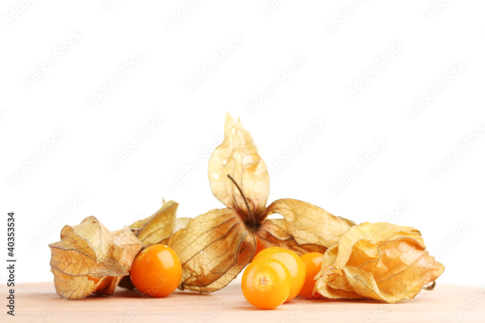 Physalis heap on wooden table on white background Physalis heap on wooden table on white background