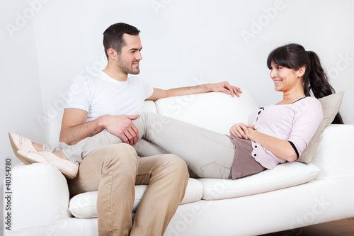 Happy young couple lying it the couch