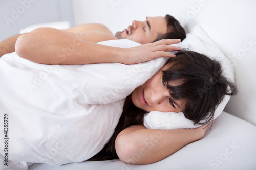 Young woman and her snoring boyfriend