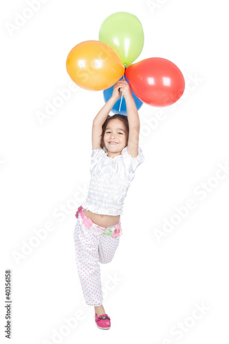 Little brunette girl with balloons in studio © Iuliia Metkalova