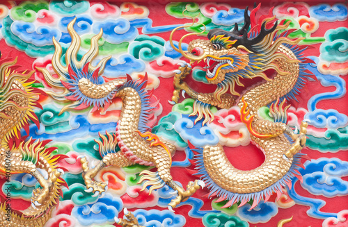 chinese dragon statue  on temple wall in Thailand