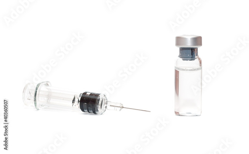 Syringe and vials on white