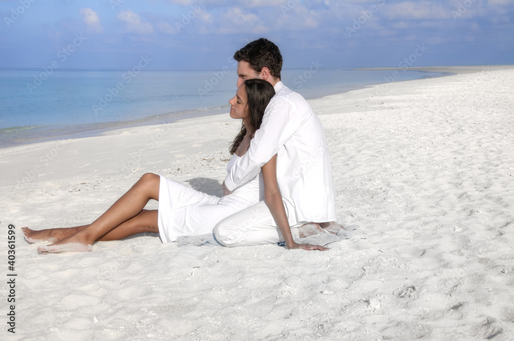 Sensual happy lovers in white clothes on the beach (Maldives)