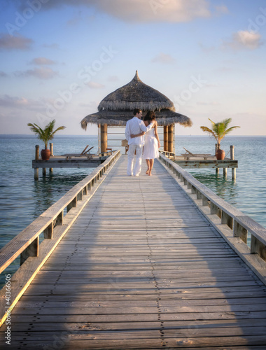 Sensual happy lovers in white clothes on the beach  Maldives 