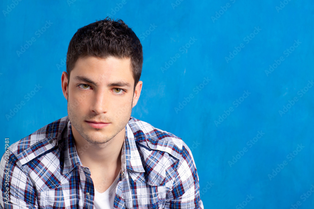 handsome young man with plaid shirt on blue handsome young man with plaid shirt on blue