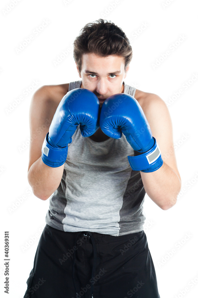 young boxer in gray shirt and blue boxing gloves