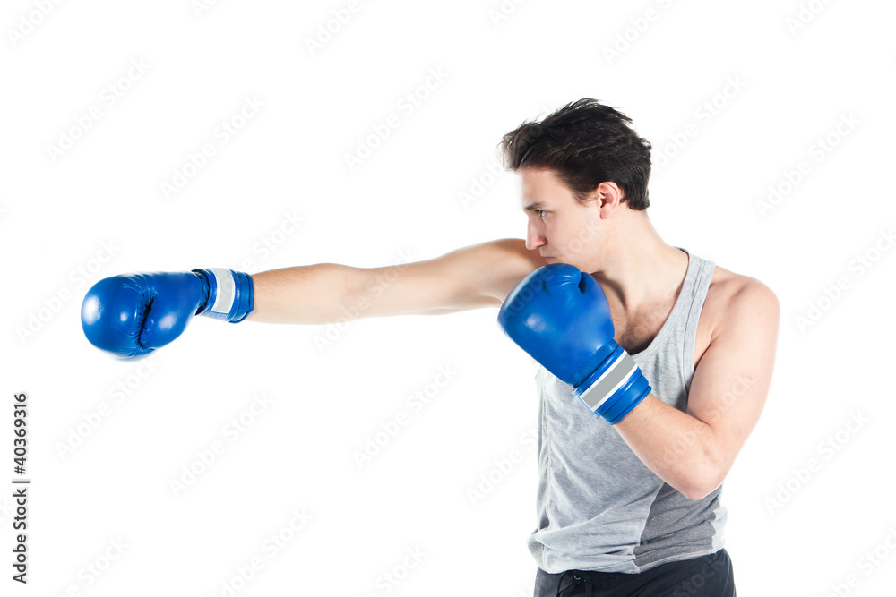 young boxer in gray shirt and blue boxing gloves young boxer in gray shirt and blue boxing gloves