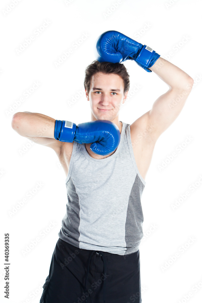 young boxer in gray shirt and blue boxing gloves young boxer in gray shirt and blue boxing gloves