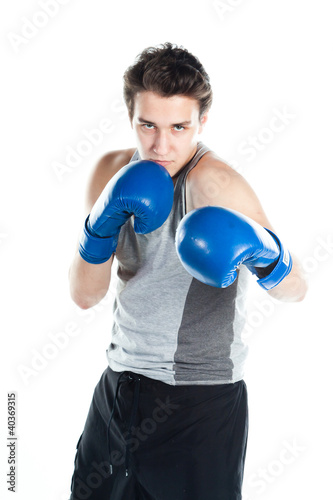young boxer in gray shirt and blue boxing gloves © korvin1979