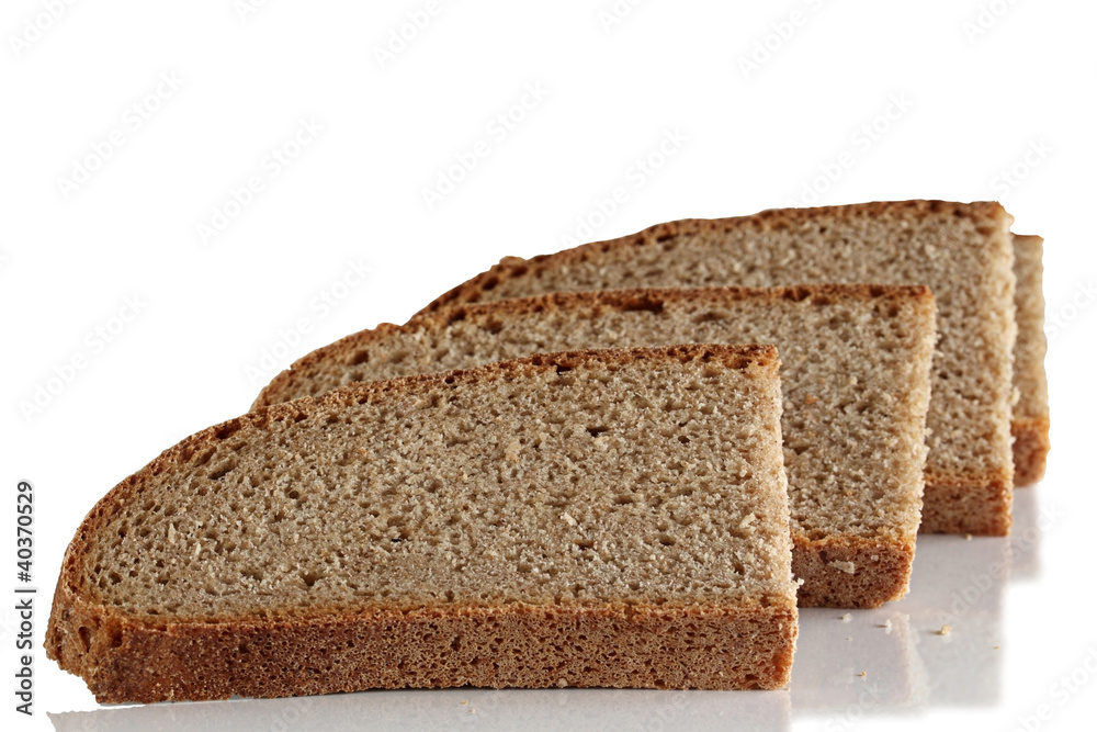 Three slices of rye bread on a white background. Three slices of rye bread on a white background.