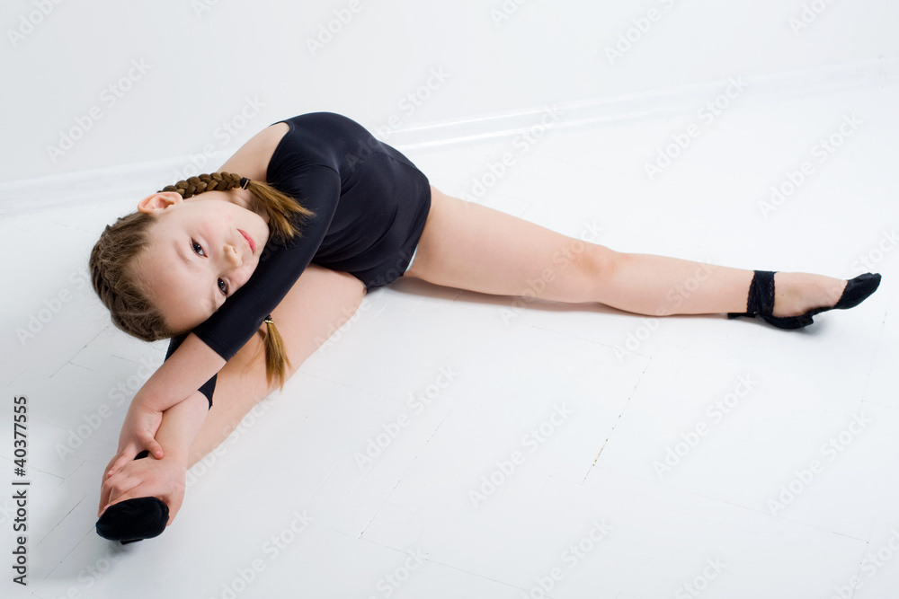 small pretty girl doing gymnastics over white background small pretty girl doing gymnastics over white background